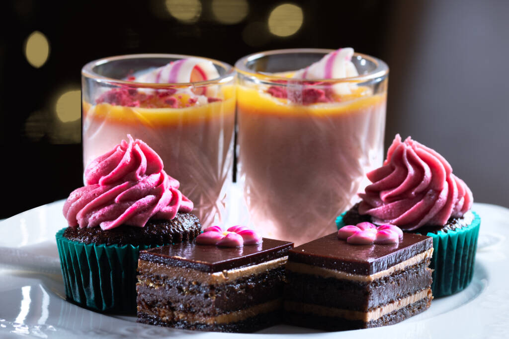 High tea black forest cupcake with cherry icing, strawberry panna cotta, lemon curd and opera slice