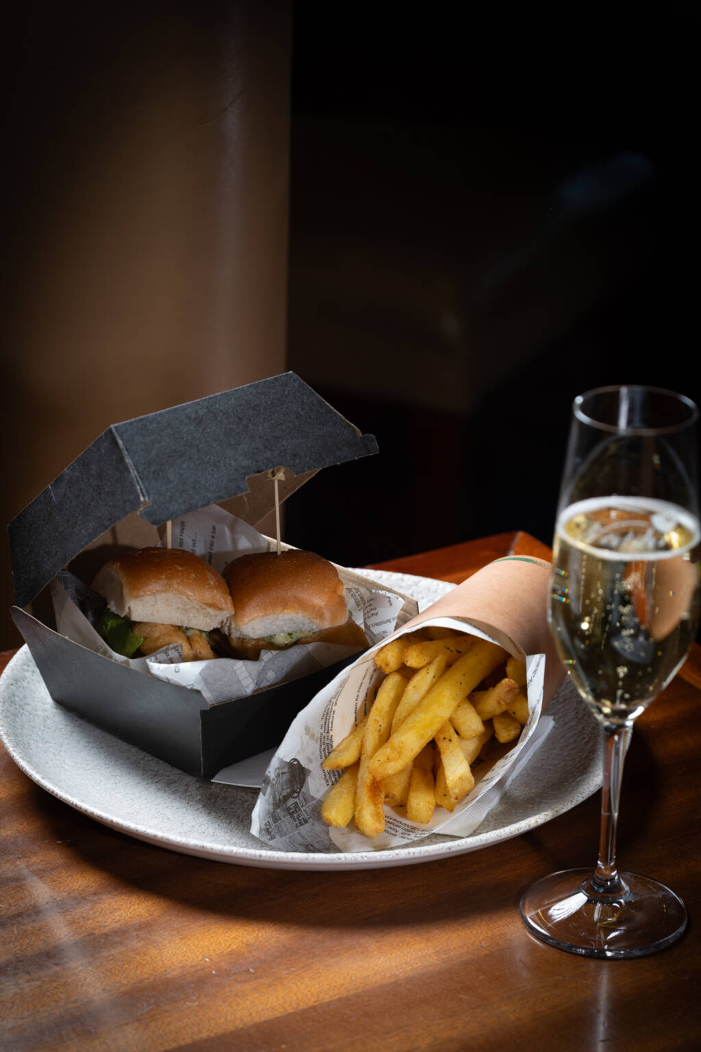 Image of two snapper sliders and a glass of champagne - the Ádult Happy Meal' at The George